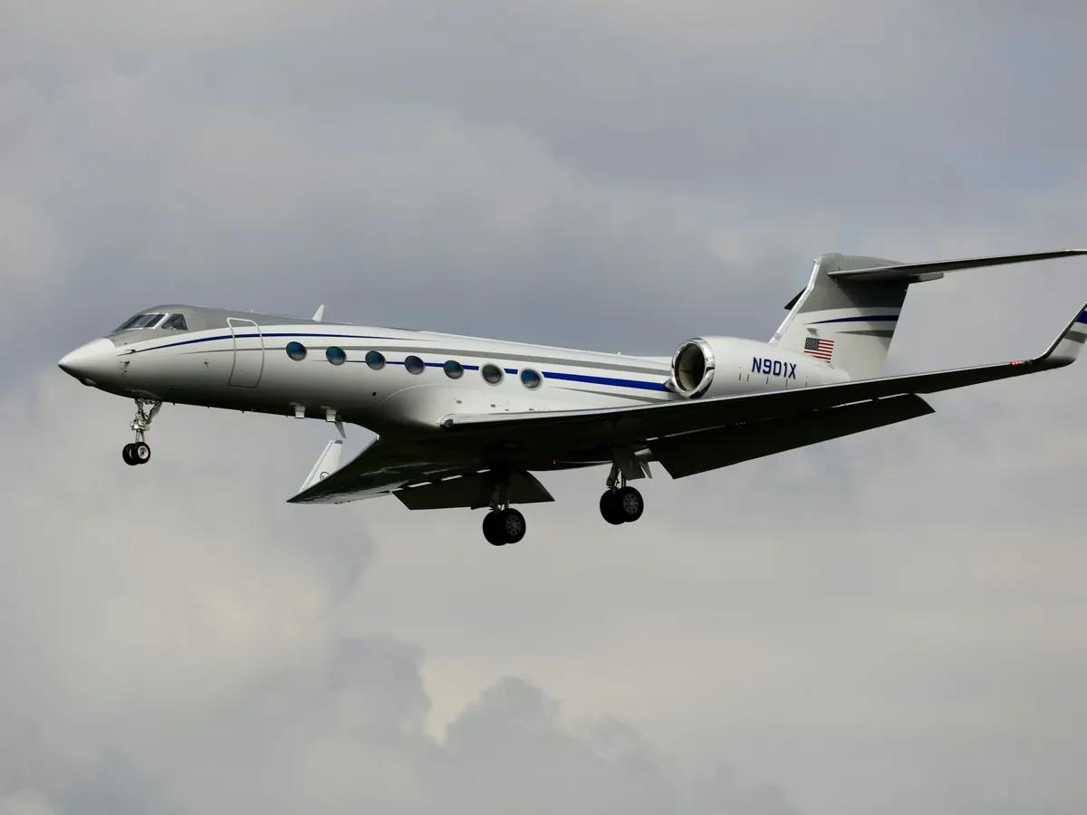 Large business jet flying above the clouds
