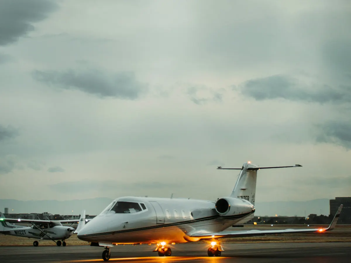 Business jet on a wet ramp under a moody sky
