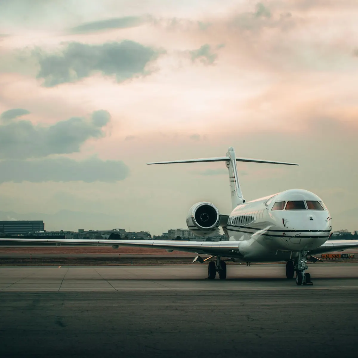 Business jet waiting on the ramp at dusk