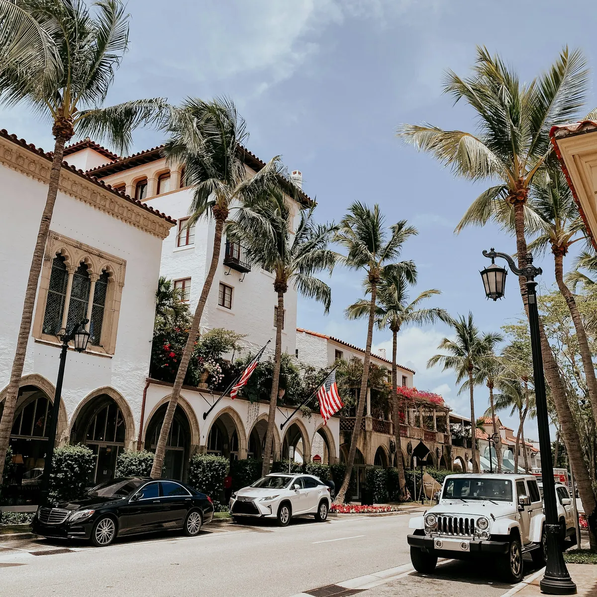 Palm-lined street with Mediterranean-style buildings in Palm Beach